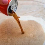 A woman creates very wonderful, fluffy bread by combining flour with cola