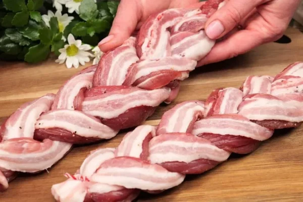 For a tasty twist, a woman wraps bacon around three slices of pork loin