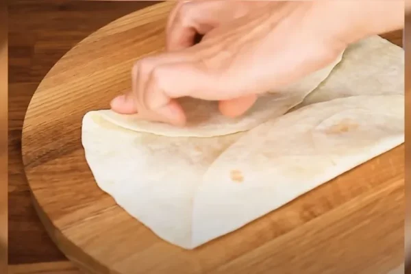 Layer tortillas with fillings after folding them into envelopes for a tasty breakfast dish