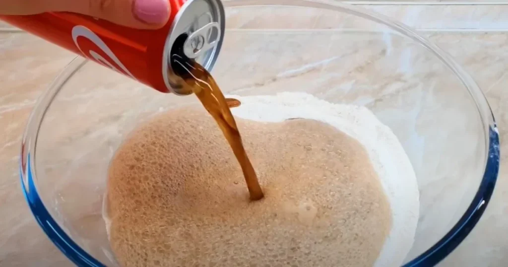 A woman creates very wonderful, fluffy bread by combining flour with cola