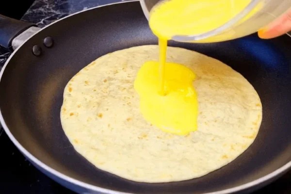 Over a tortilla, pour eggs for a tasty family-friendly dinner